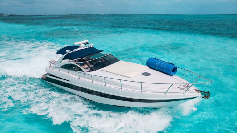 Aerial port view of 50 ft Pershing Icaro sport yacht charter cruising at high speed over vivid turquoise Caribbean water near Cancun