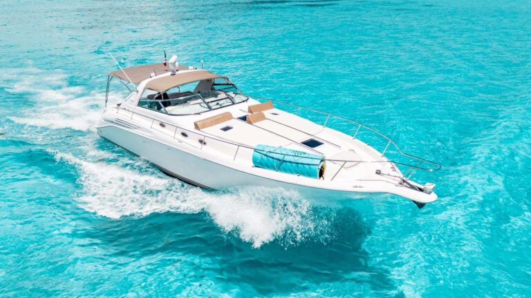 Aerial view of the 45 ft Sea Ray Final Answer cruising at speed over turquoise Caribbean water with bow sun pads visible for a Cancun yacht charter